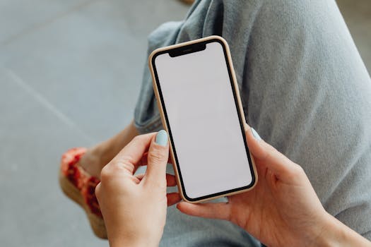 Image for art business terms and conditions page of a woman holding smartphone with blank screen, representing online privacy and digital consent in an art business.