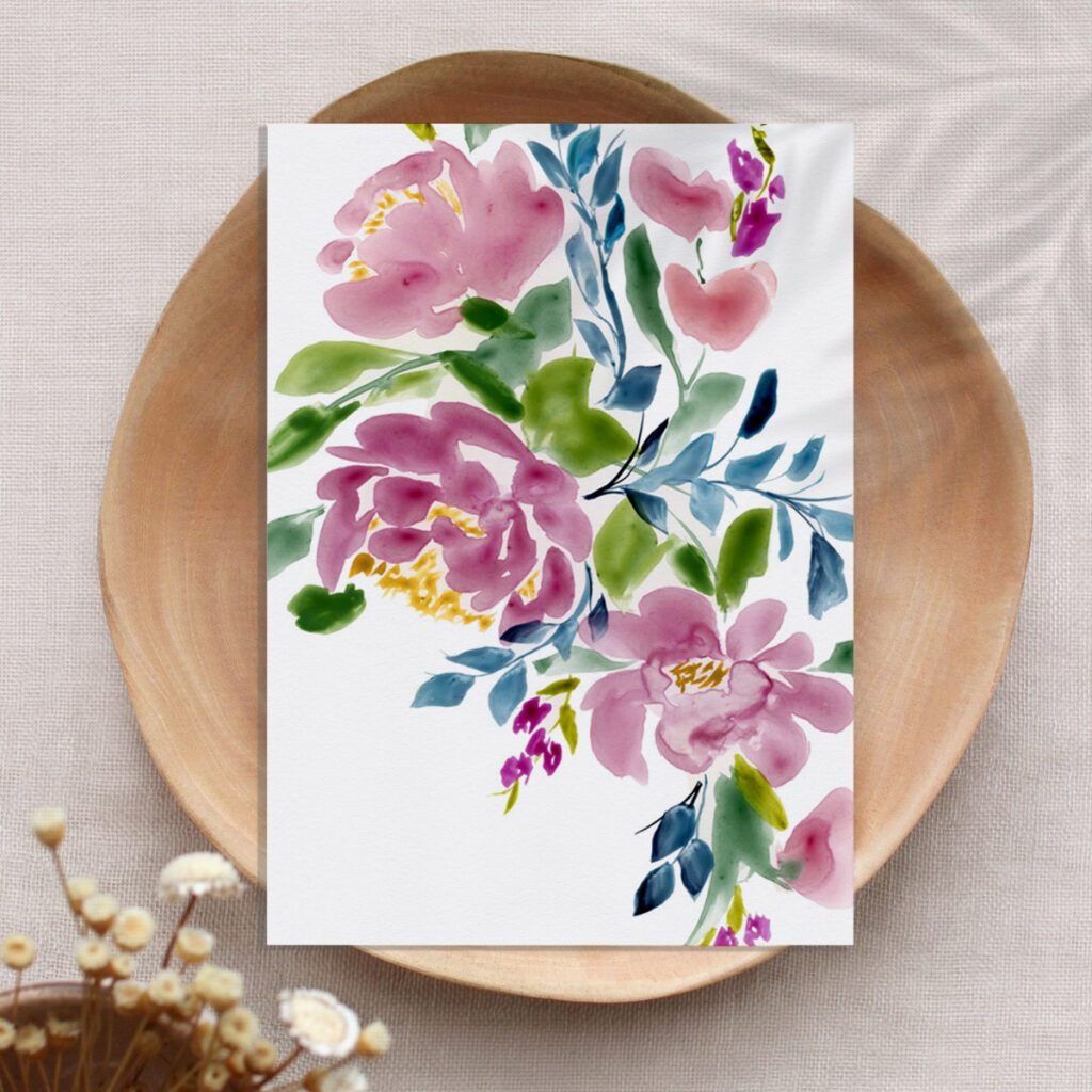 Unframed watercolor floral art print styled in a wooden bowl with neutral blooms and natural light.