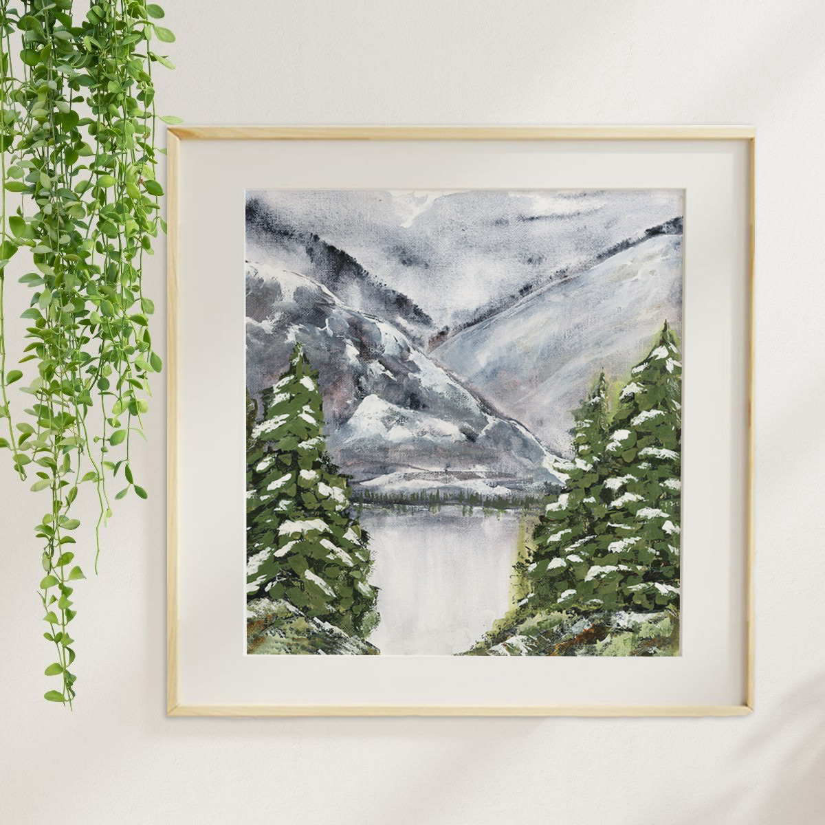 The Lake Remembers watercolor winter lake art print with snowy evergreens and a large mountain in the background.